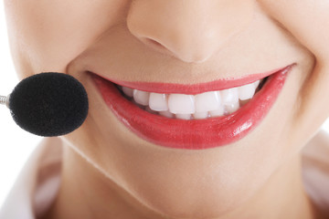 Fototapeta premium Smiling telemarketing operator with microphone