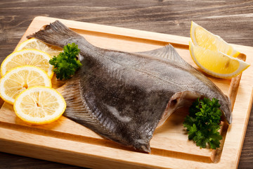Fresh raw flounder on cutting board