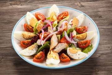 Boiled eggs with roast chicken fillet and vegetables