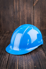 Construction hard hat on wooden background