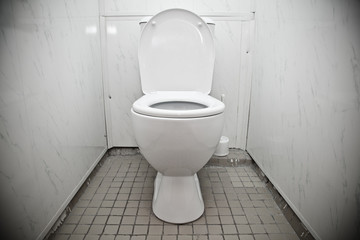 Naklejka na ściany i meble White toilet bowl in a bathroom