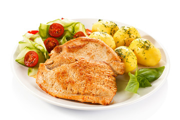 Fried pork chops, boiled potatoes and vegetable salad