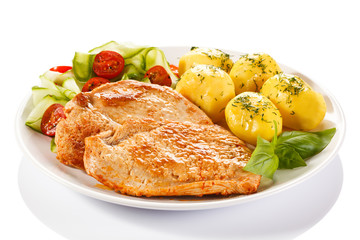 Fried pork chops, boiled potatoes and vegetable salad