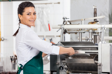 Happy Female Chef Processing Ravioli Pasta In Machine