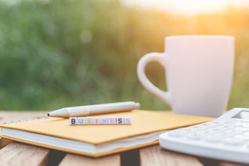 Business written in letter beads and a coffee cup on table