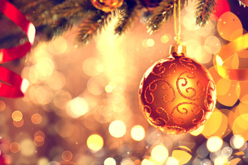 Christmas decoration. Golden bauble hanging on Christmas tree