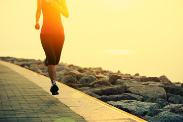  woman runner athlete running at sunrise seaside
