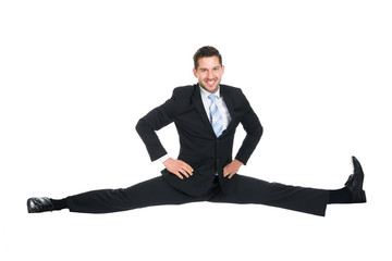 Businessman Doing Splits Over White Background