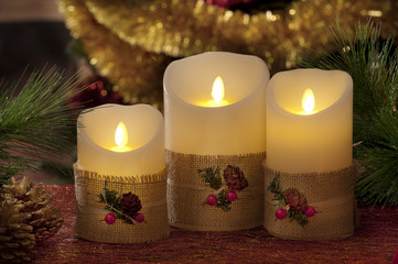 electric candles with christmas decorations in atmospheric light