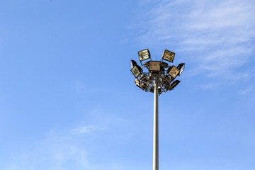 Spot light pole with blue sky in the stadium