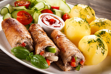 Wrapped pork chop, boiled potatoes and vegetables