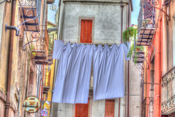 Laundry line with bed sheets in Bosa old town, Sardinia