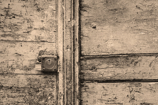 rusty keyhole in a wooden door in black and white