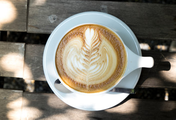 A white cup of latte from top view