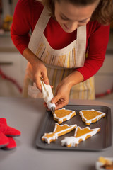 Closeup on young housewife making christmas cookies