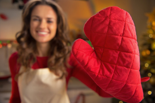 Closeup On Young Housewife Showing Red Kitchen Gloves