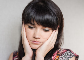 Woman with headache holding head with hands