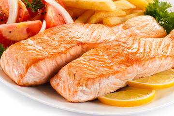 Grilled salmon and vegetables on white background