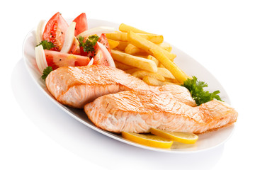 Grilled salmon and vegetables on white background