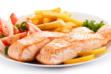 Grilled salmon and vegetables on white background