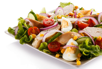 Roast chicken fillet and vegetables on white background