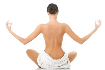Foto op Plexiglas Back view of a woman in towel practising yoga © Piotr Marcinski