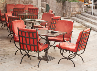 empty street cafe with red chairs