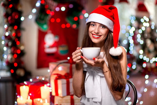 Young woman with coffee cup on Christmas