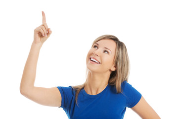 Fototapeta premium Close up surprised woman pointing to the corner