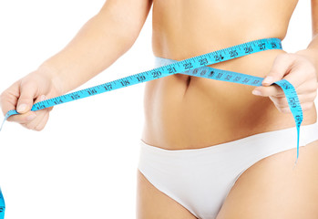 Close up on woman measuring her waist