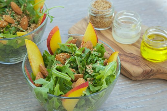 Vitamin salad- rucola with fruits and nuts. Close up