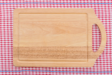 wood cutting board on tablecloth