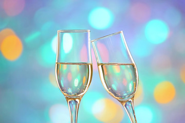 Two champagne glasses on colorful background