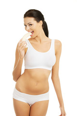 Fototapeta premium Attractive woman eating a banana