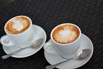 Cup of cappuccino on the black background