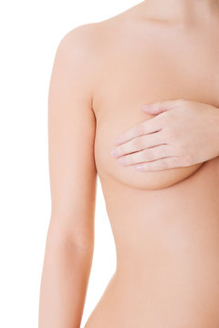 Close up nude woman examining her breast