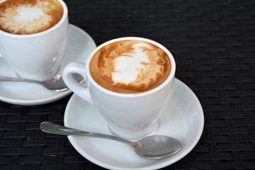 Cup of cappuccino on the black background