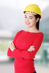 Portrait of confident female worker in helmet.