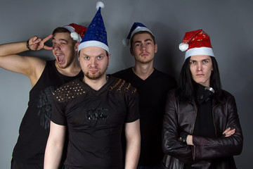 Man's metal band with red and blue christmas hats