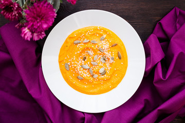 Pumpkin cream-soup with seeds in a plate