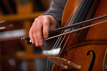 Detail of the cello in the hands of a musician © furtseff