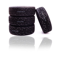 Set of studded winter tires isolated on white background