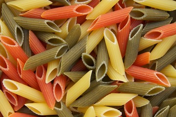 Raw three-colored Italian pasta. Background