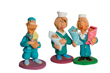 Statuette of doctors with three babies in their arms
