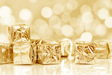 Small Christmas gifts in shiny golden paper