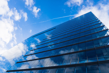 blue glass wall of skyscraper.  Buildings abstract