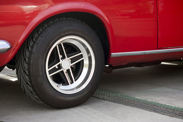 Fototapeta na wymiar Wheel of a red classic car.