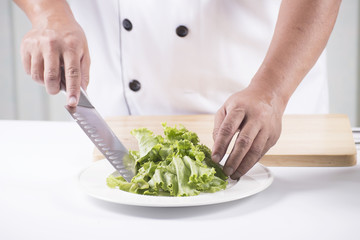Chef cutting lettuce