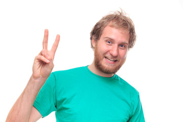 Naklejka premium Bearded happy man showing victory sign