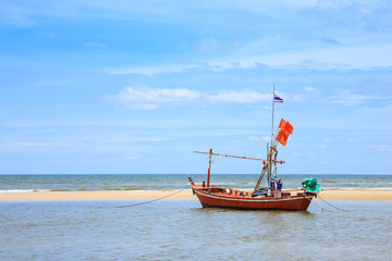 Fototapeta premium Traditional fishing boat on beach and blue sky